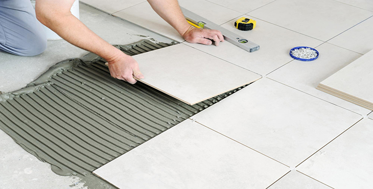 hands-worker-are-laying-ceramic-tile-floor copy